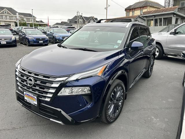 2025 Nissan Rogue AWD Platinum in Deep Ocean Blue Pearl — front three-quarter view
